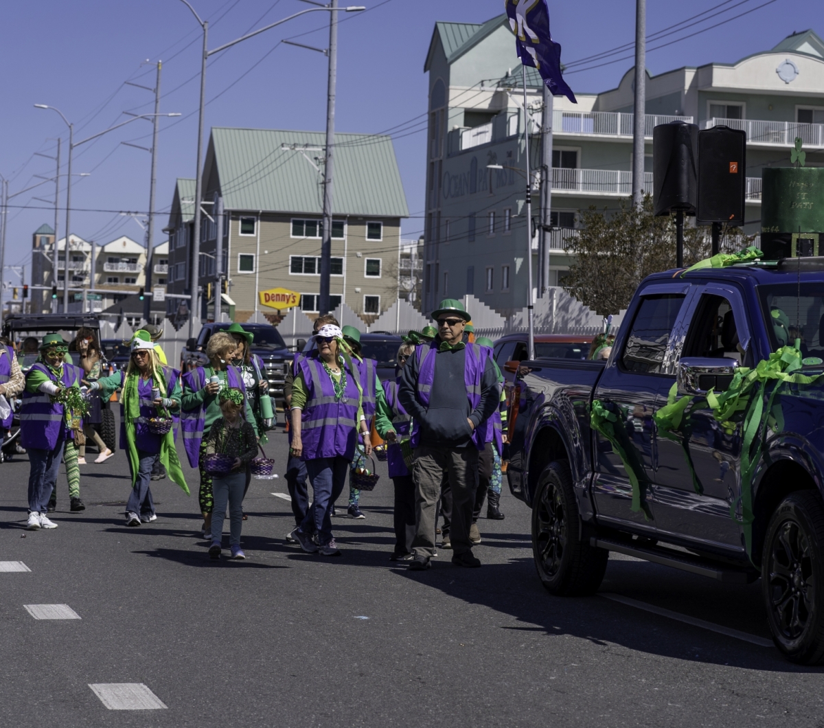 Group of people wearing purple and green at the parade