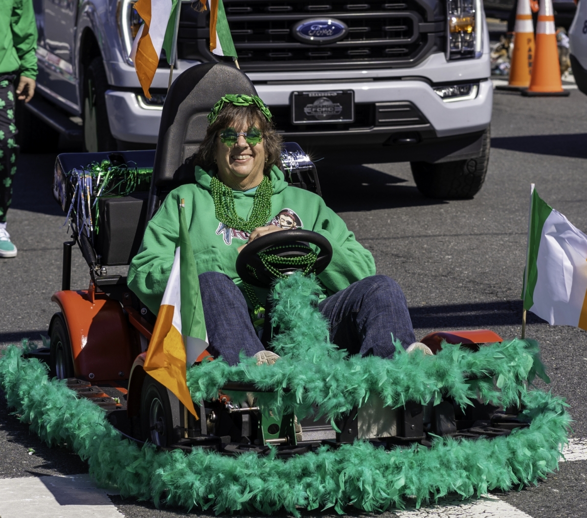 Lady riding a St. Patrick's Day go kart